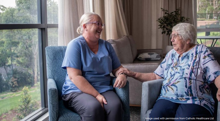 Care worker engaging with an older woman