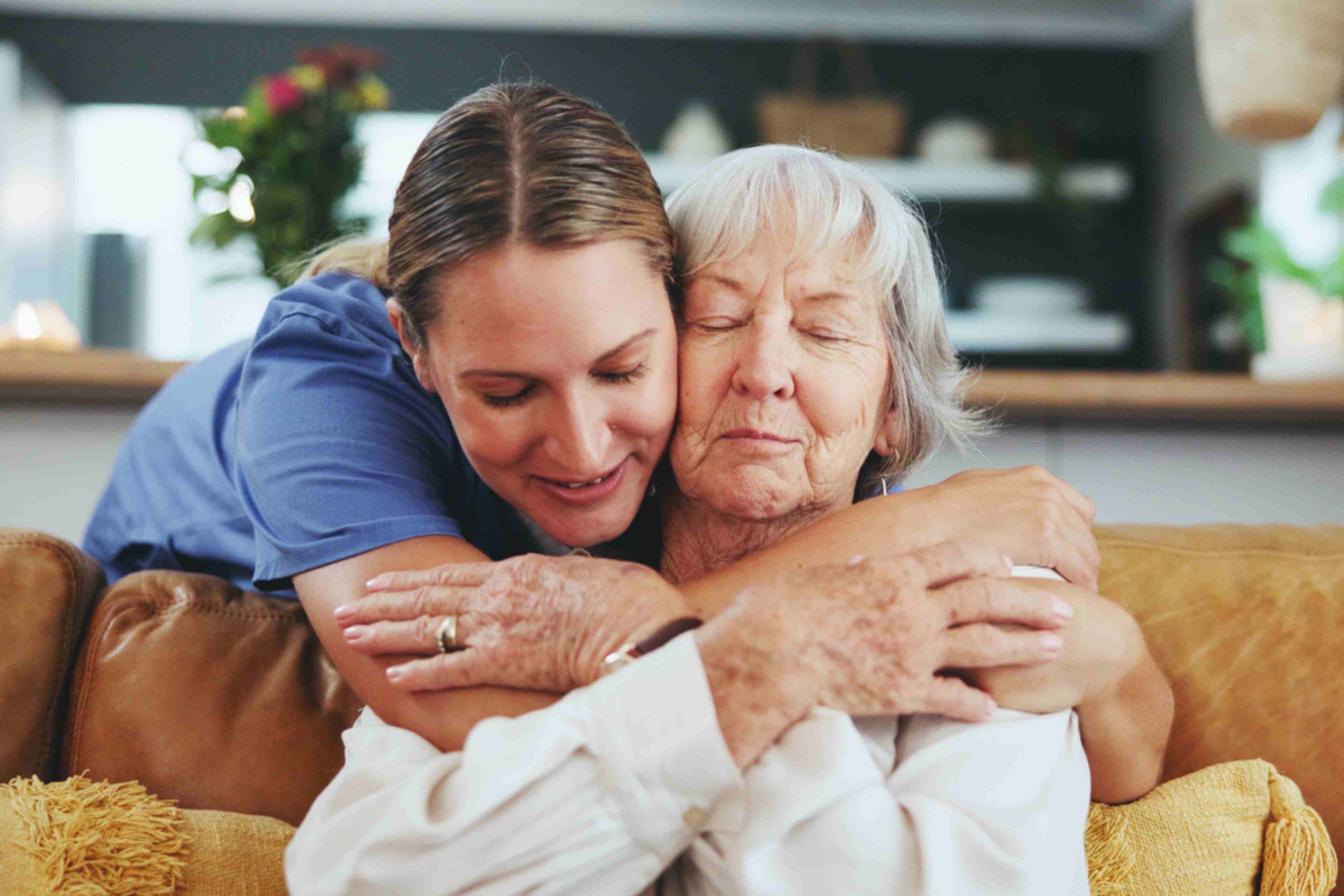 A heartfelt embrace between an elderly woman, a middle-aged adult, and a child conveys emotional support, family connection, and compassionate care.