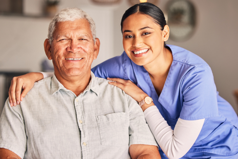 A caregiver and an elderly woman share a joyful moment, laughing together &mdash; conveying warmth, companionship, and emotional connection.